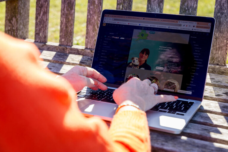 Lorraine Cheney working at a laptop on Southend Sea front