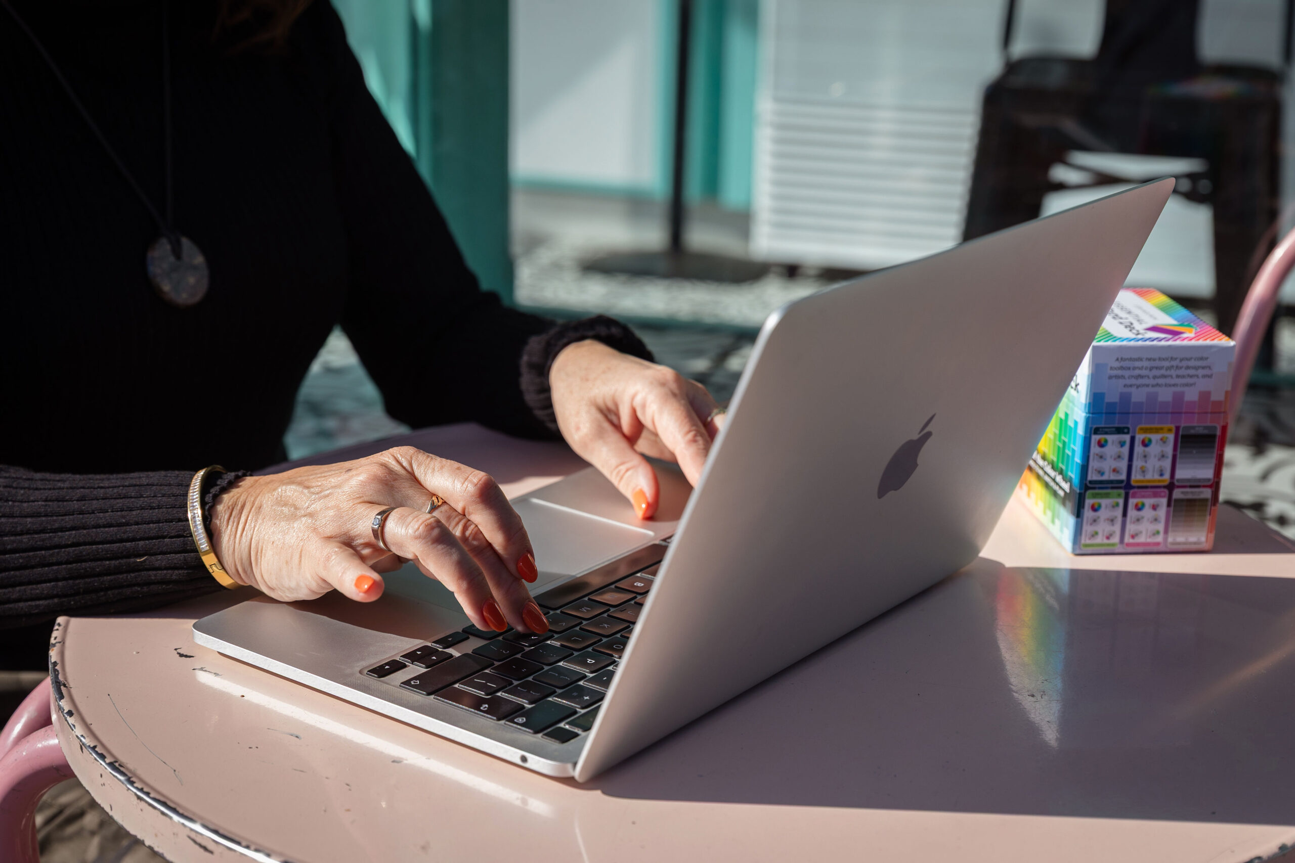Lorraine Cheney working at a laptop on Southend Sea front cafe